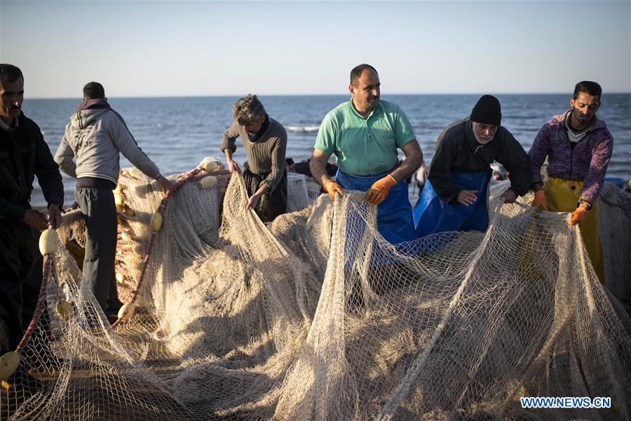 Iranian fishermen work at the Caspian sea beach near Anzali Port, northern Iran, on March 27, 2017. (Xinhua/Ahmad Halabisaz)  Iranian fishermen work at the Caspian sea beach near Anzali Port, northern Iran, on March 27, 2017. (Xinhua/Ahmad Halabisaz)
